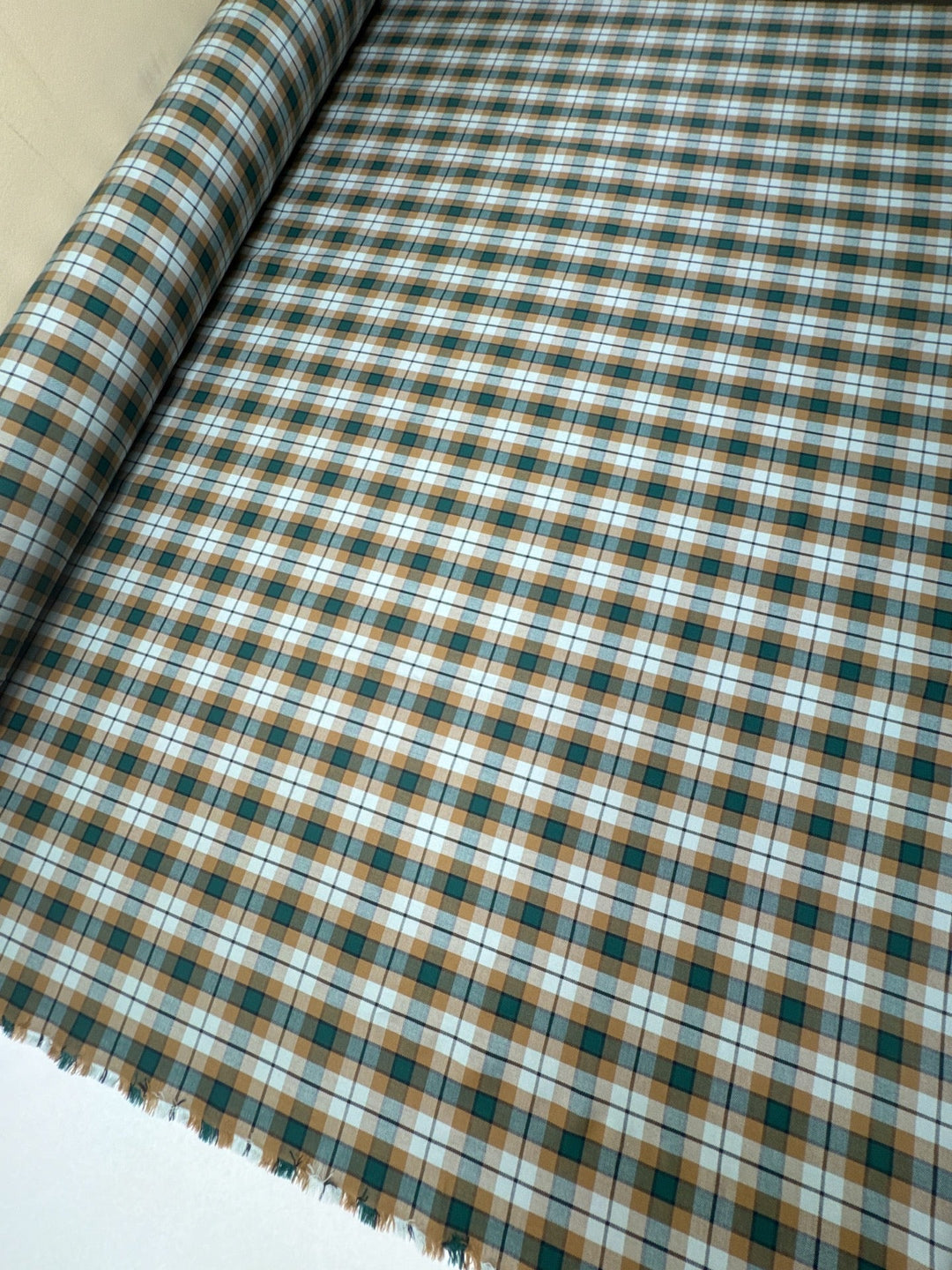 Italian cotton tweed fabric in cream, green, and brown plaid twill weave, lightweight and structured for coats, suiting, and dresses.