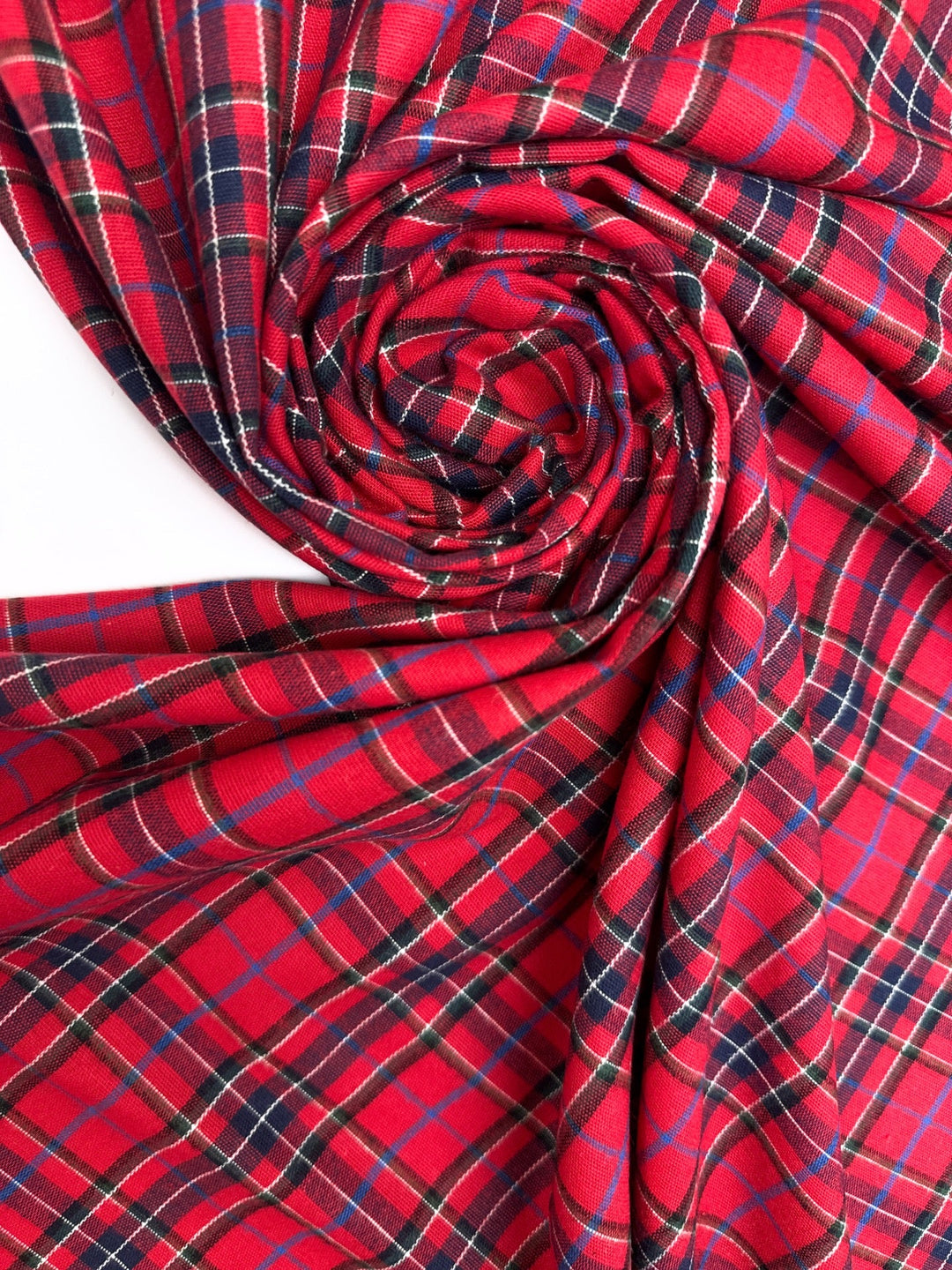 Italian cotton flannel fabric in bright red and black plaid, lightweight textile for shirts, blouses, and casual wear.