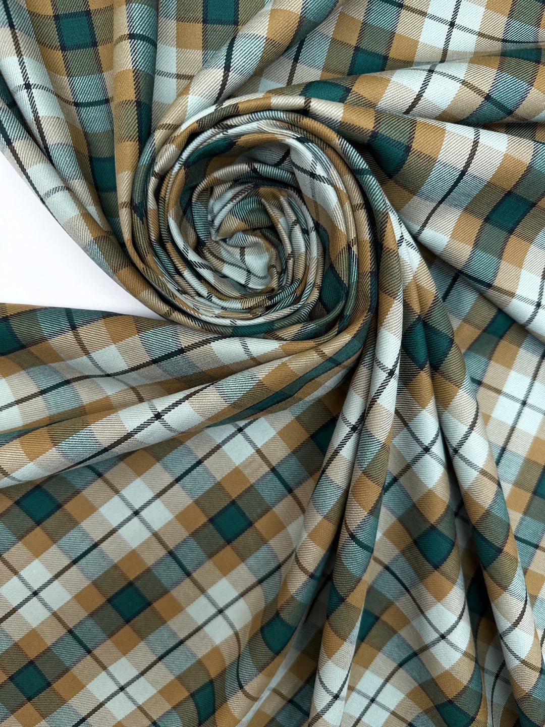 Italian cotton tweed fabric in cream, green, and brown plaid twill weave, lightweight and structured for coats, suiting, and dresses.