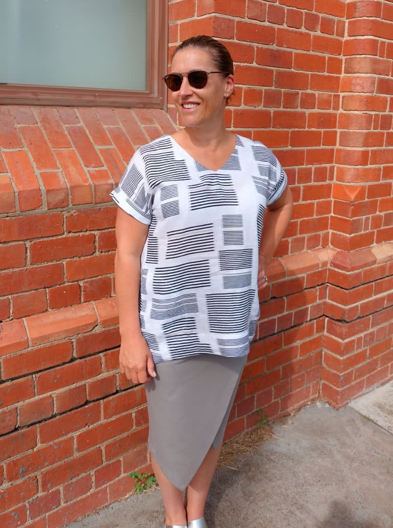 Style Arc Elani Tunic sewing pattern with dropped shoulders, turned-back cuffs, inseam pockets, and dropped back hem