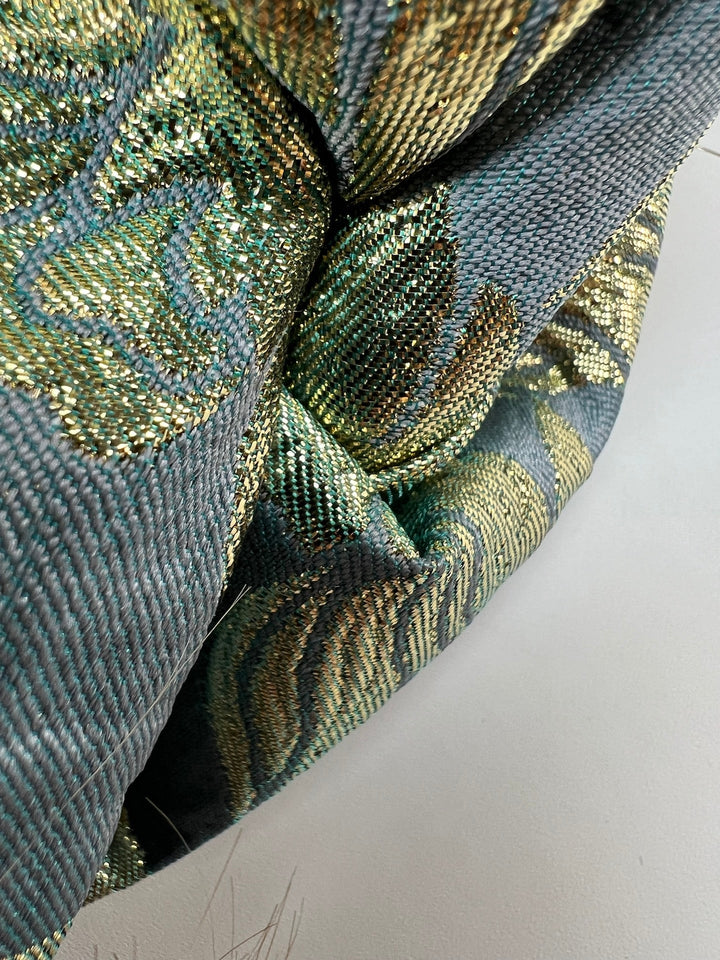 French jacquard fabric with metallic leaf pattern in teal and gold, polyester lurex acrylic blend, ideal for bridal gowns, evening dresses, and formalwear.