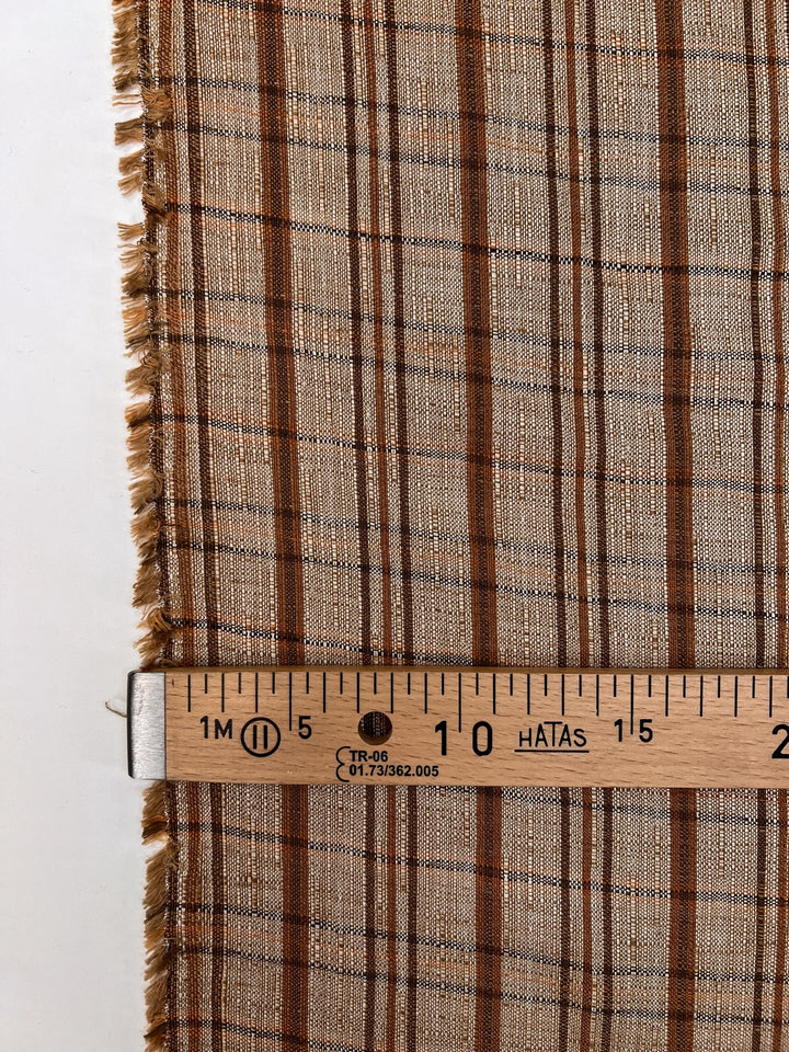 Italian plaid tweed fabric in browns and beige, viscose cotton blend, lightweight textile for structured coats, suiting, skirts, and dresses.