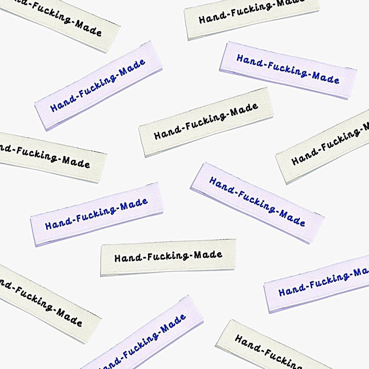Kylie and the Machine 'Hand Fcking Made' woven labels in cream/black and lilac/blue – playful sewing labels for proud makers