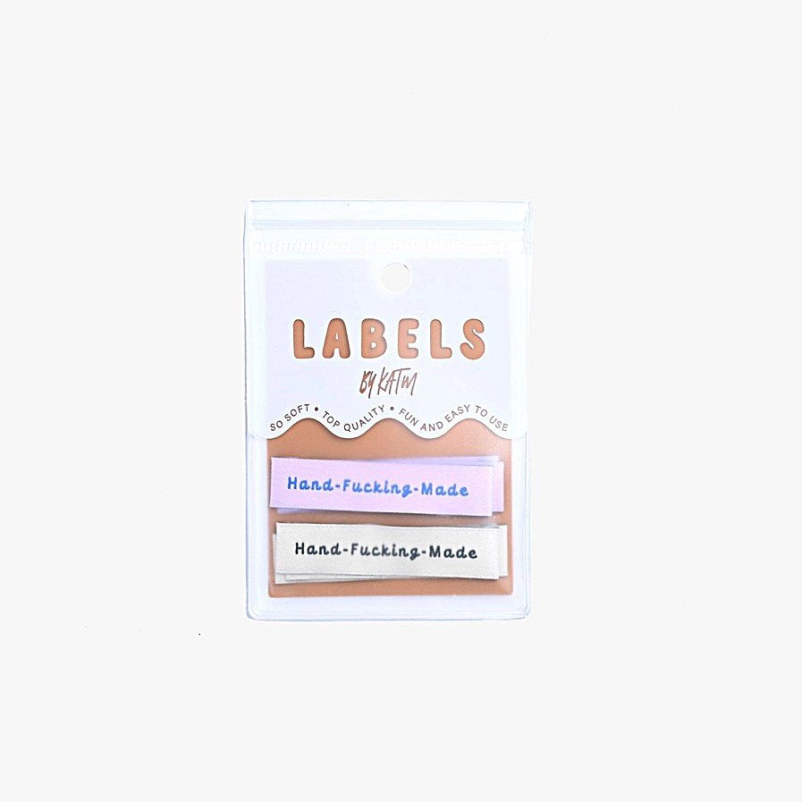 Kylie and the Machine 'Hand Fcking Made' woven labels in cream/black and lilac/blue – playful sewing labels for proud makers
