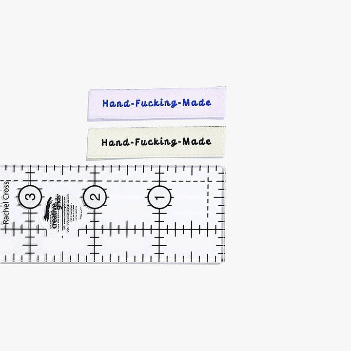 Kylie and the Machine 'Hand Fcking Made' woven labels in cream/black and lilac/blue – playful sewing labels for proud makers