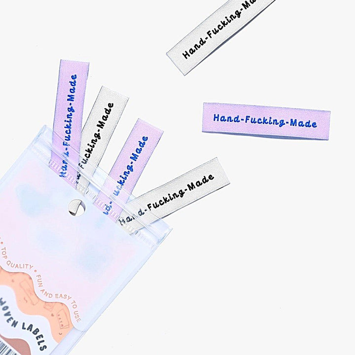 Kylie and the Machine 'Hand Fcking Made' woven labels in cream/black and lilac/blue – playful sewing labels for proud makers
