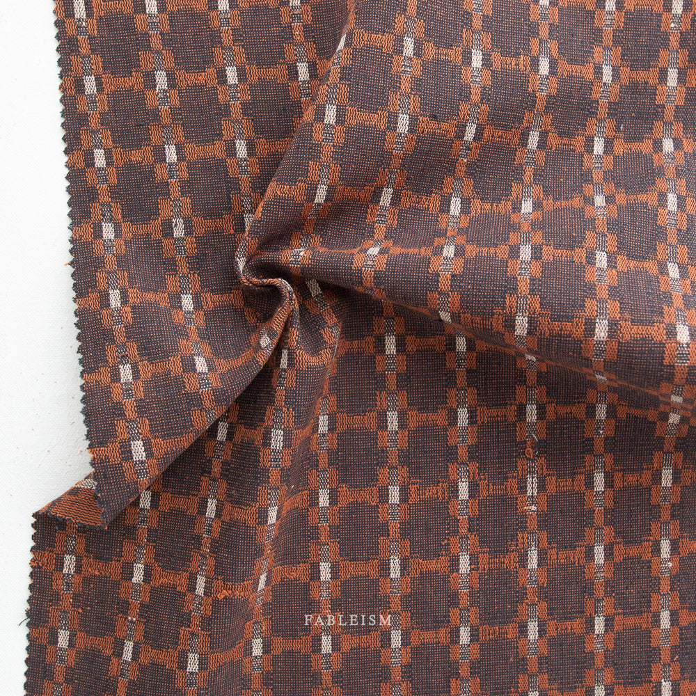Cotton Woven Monarch Grove fabric in brown and rust tones, 100% cotton, ideal for shirts, blouses, dresses, and skirts.