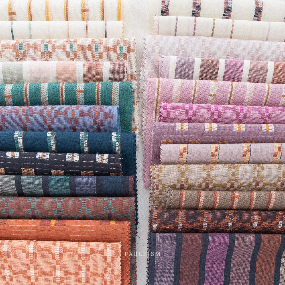 Cotton woven fabric in monarch grove design with blue and rust tones – 100% cotton material for shirts, blouses, dresses, and skirts.