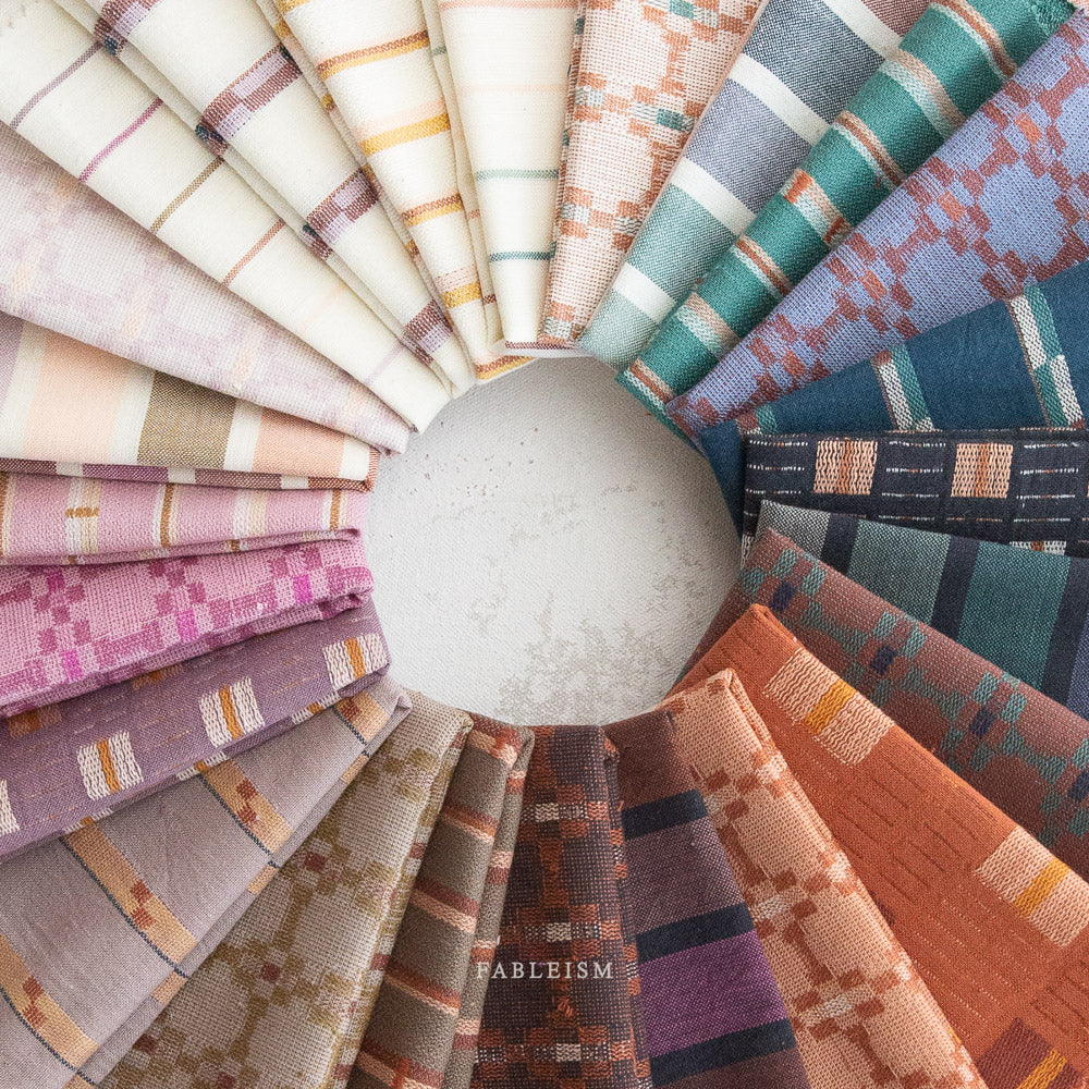 Cotton woven fabric in monarch grove design with blue and rust tones – 100% cotton material for shirts, blouses, dresses, and skirts.