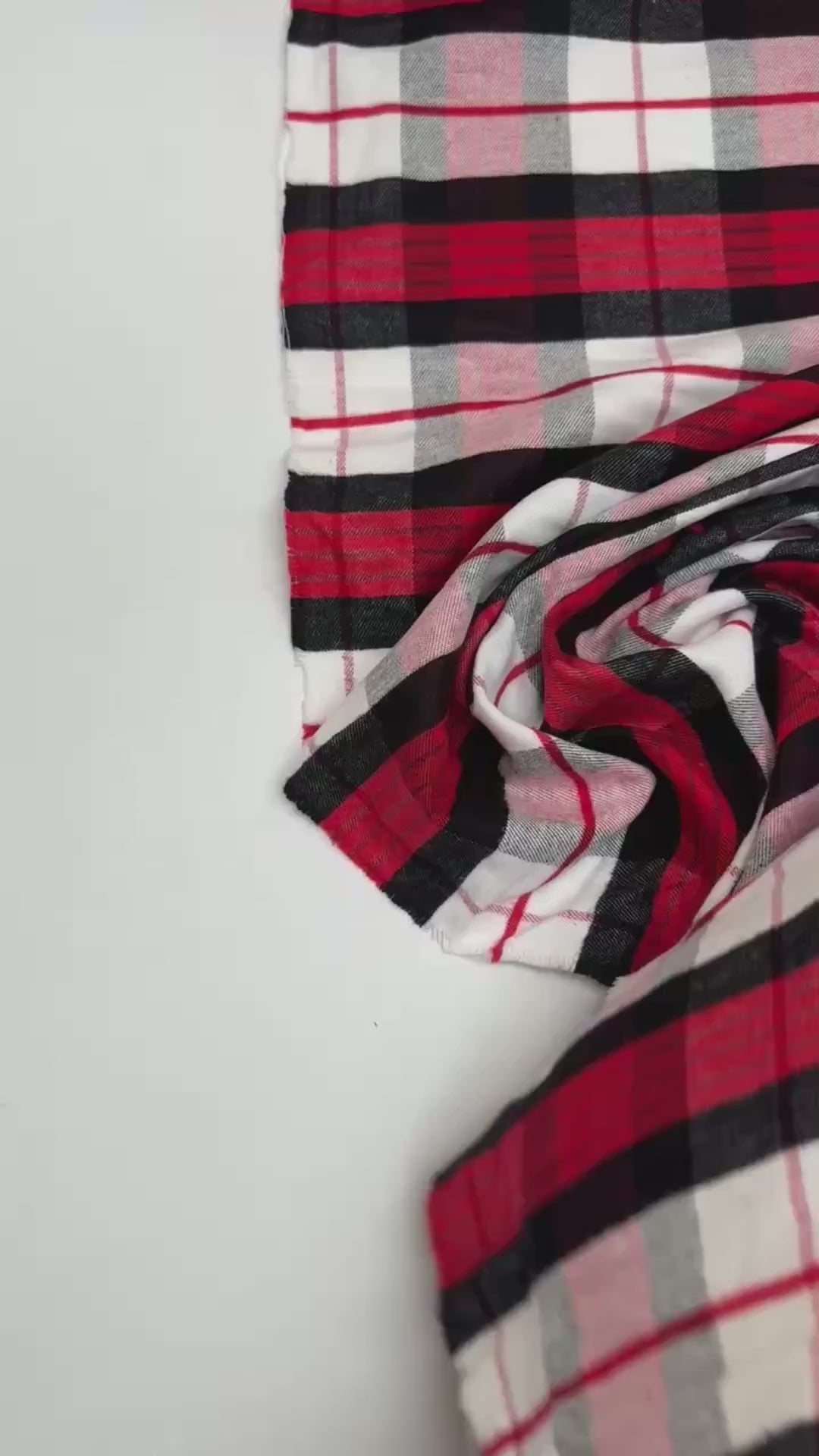 Italian cotton flannel fabric in large white, black, and red plaid, lightweight textile ideal for shirts, blouses, and casual wear.