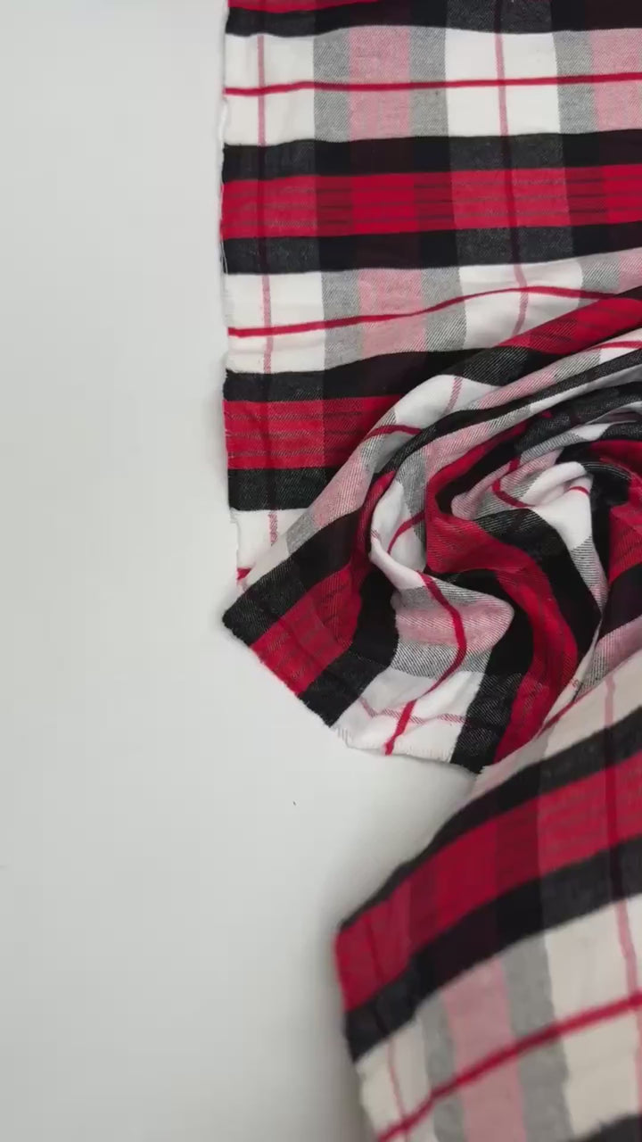 Italian cotton flannel fabric in large white, black, and red plaid, lightweight textile ideal for shirts, blouses, and casual wear.