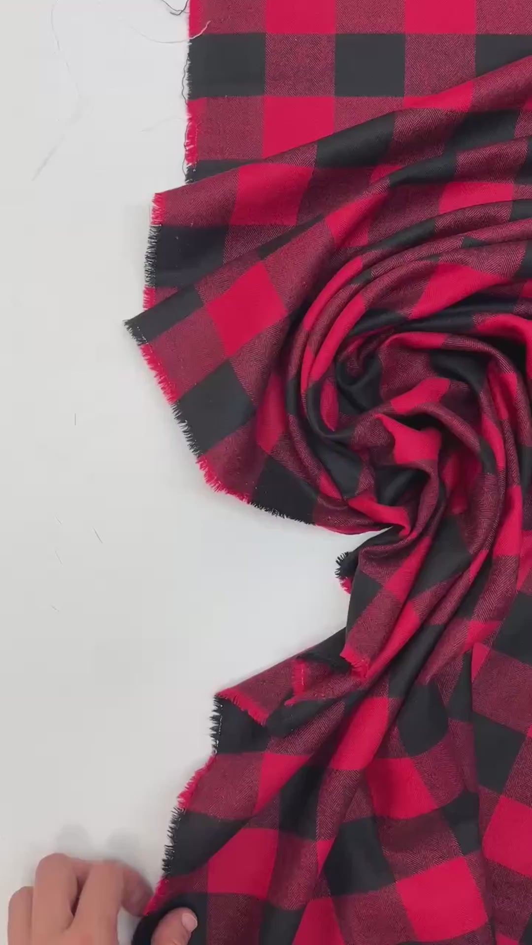 Italian cotton flannel fabric in red and black buffalo plaid, lightweight textile ideal for shirts, blouses, and casual wear.