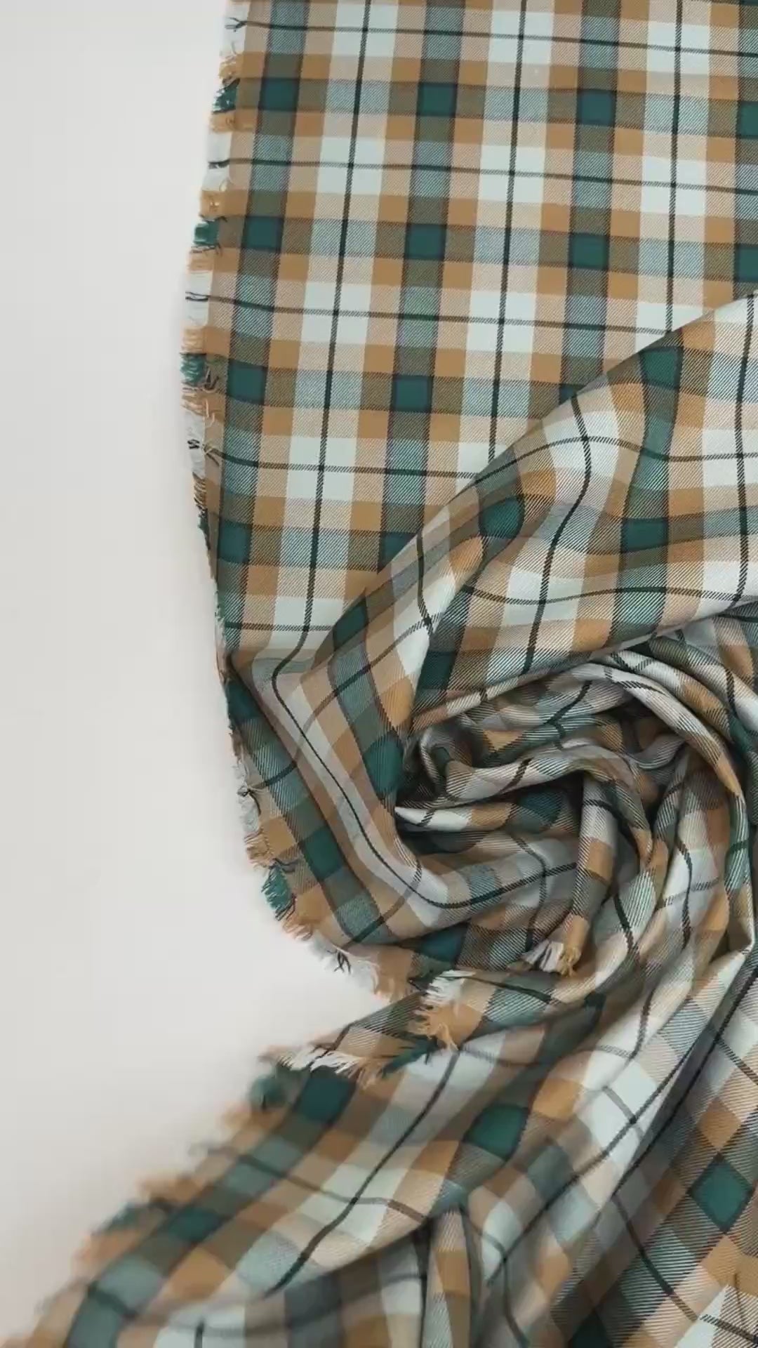 Italian cotton tweed fabric in cream, green, and brown plaid twill weave, lightweight and structured for coats, suiting, and dresses.
