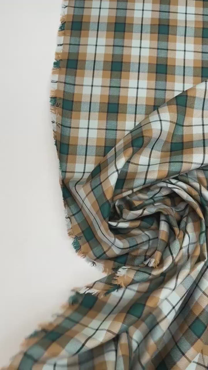 Italian cotton tweed fabric in cream, green, and brown plaid twill weave, lightweight and structured for coats, suiting, and dresses.