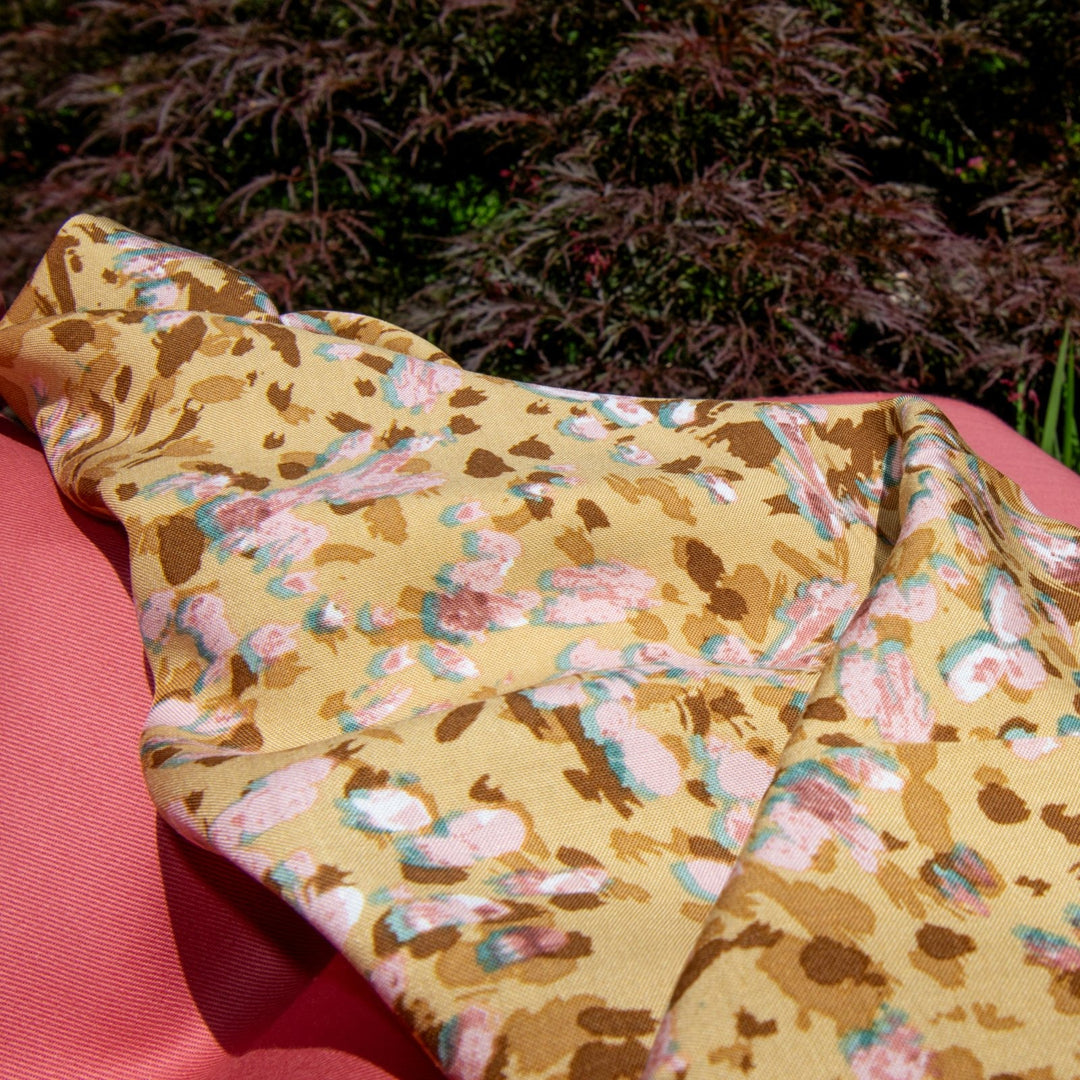 Rayon Challis fabric in buttery caramel abstract pattern, 56-inch wide, lightweight and flowing, ideal for dresses and blouses.