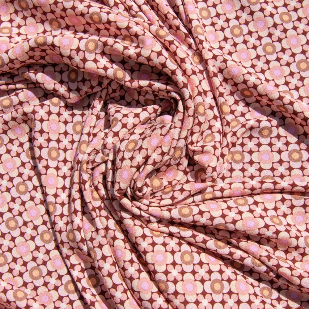 Rayon Crepe fabric in wine color with symmetrical apricot and blush mod floral pattern, 52 inches wide, ideal for sewing dresses and blouses