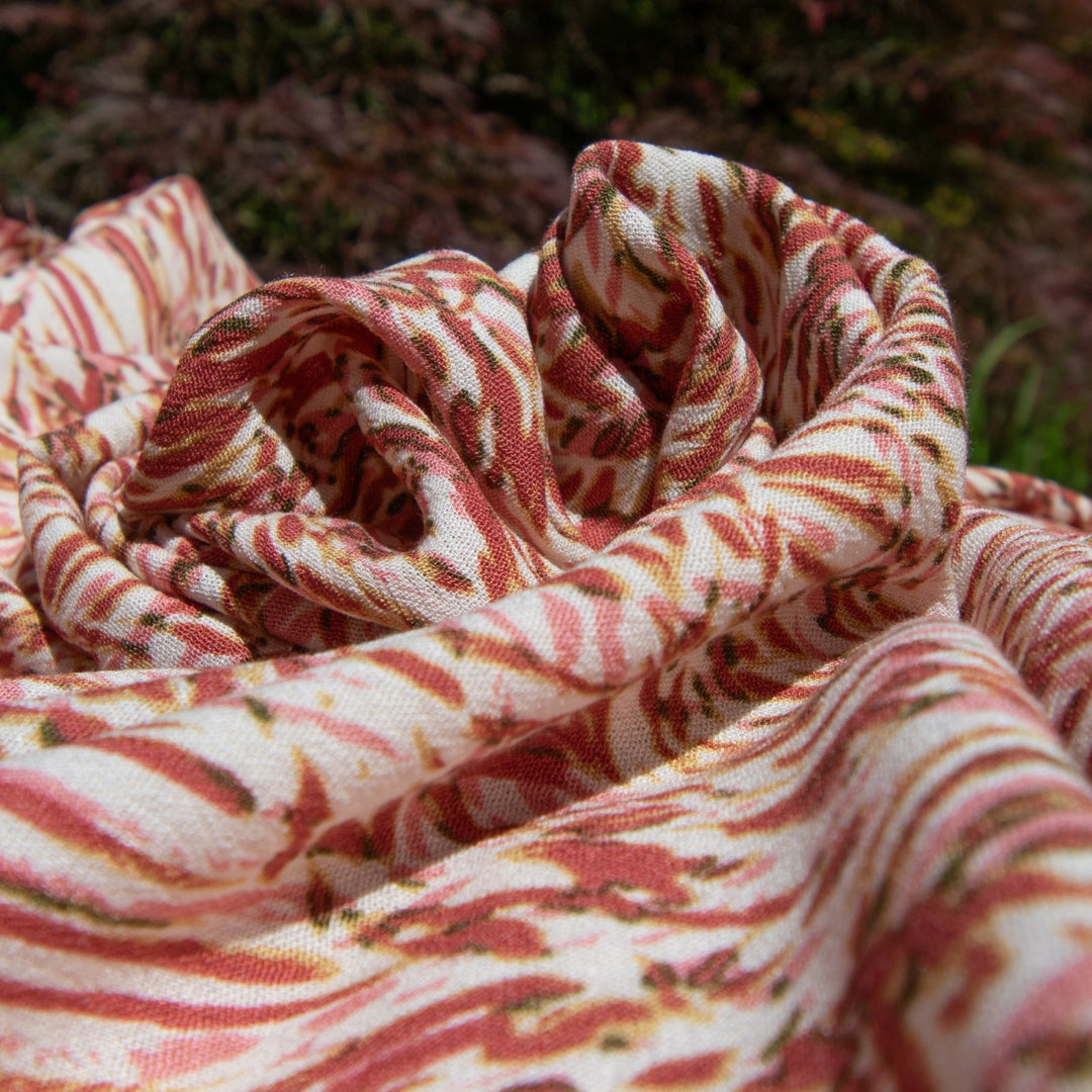 Rayon Crepe fabric in berries, pink, and caramel abstract print on cream, soft flowing textile for dressmaking and skirts