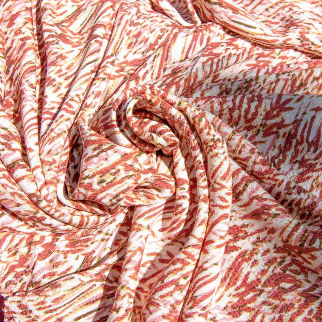 Rayon Crepe fabric in berries, pink, and caramel abstract print on cream, soft flowing textile for dressmaking and skirts