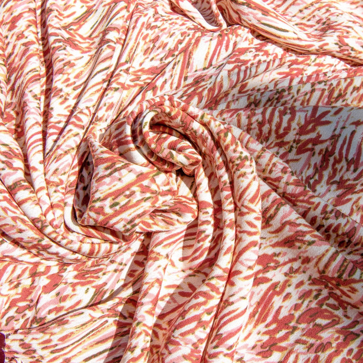 Rayon Crepe fabric in berries, pink, and caramel abstract print on cream, soft flowing textile for dressmaking and skirts