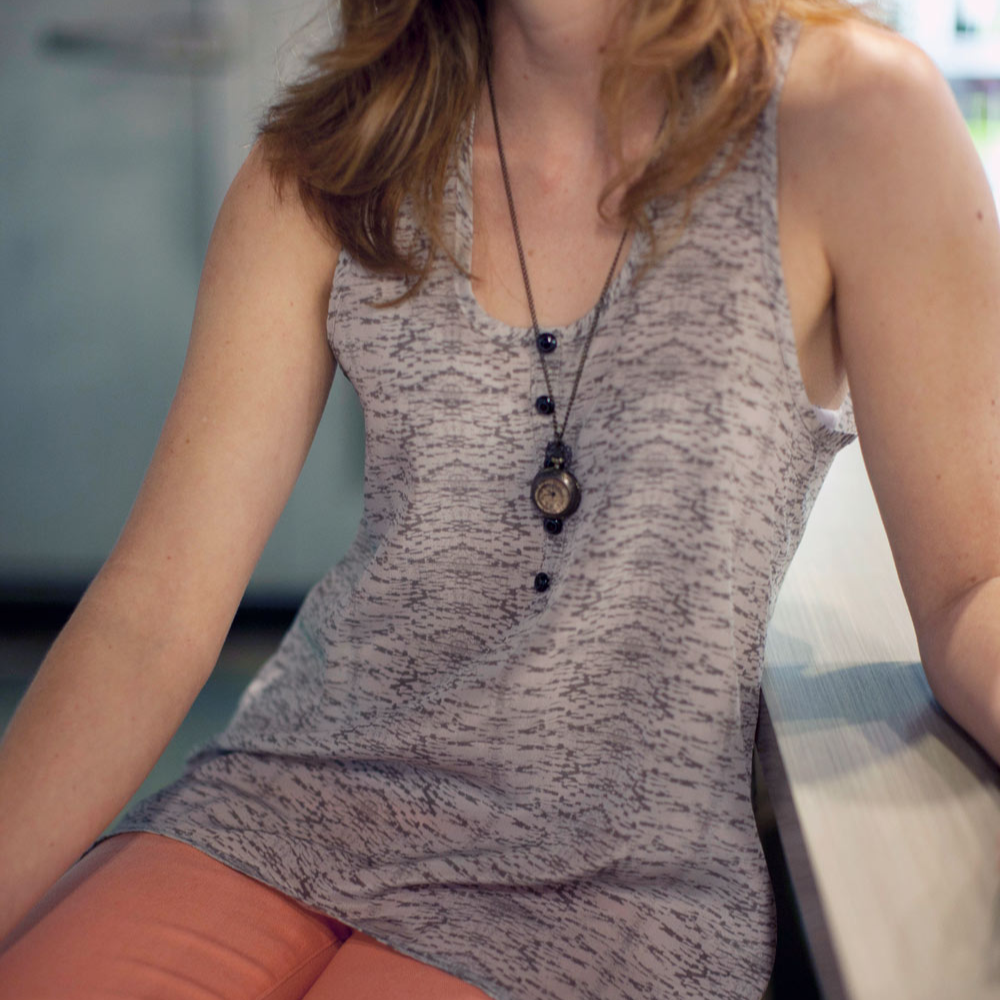 Sew Liberated Myla Tank sewing pattern with flared shaping, split skirt detail, low back hem, and customizable faux placket design